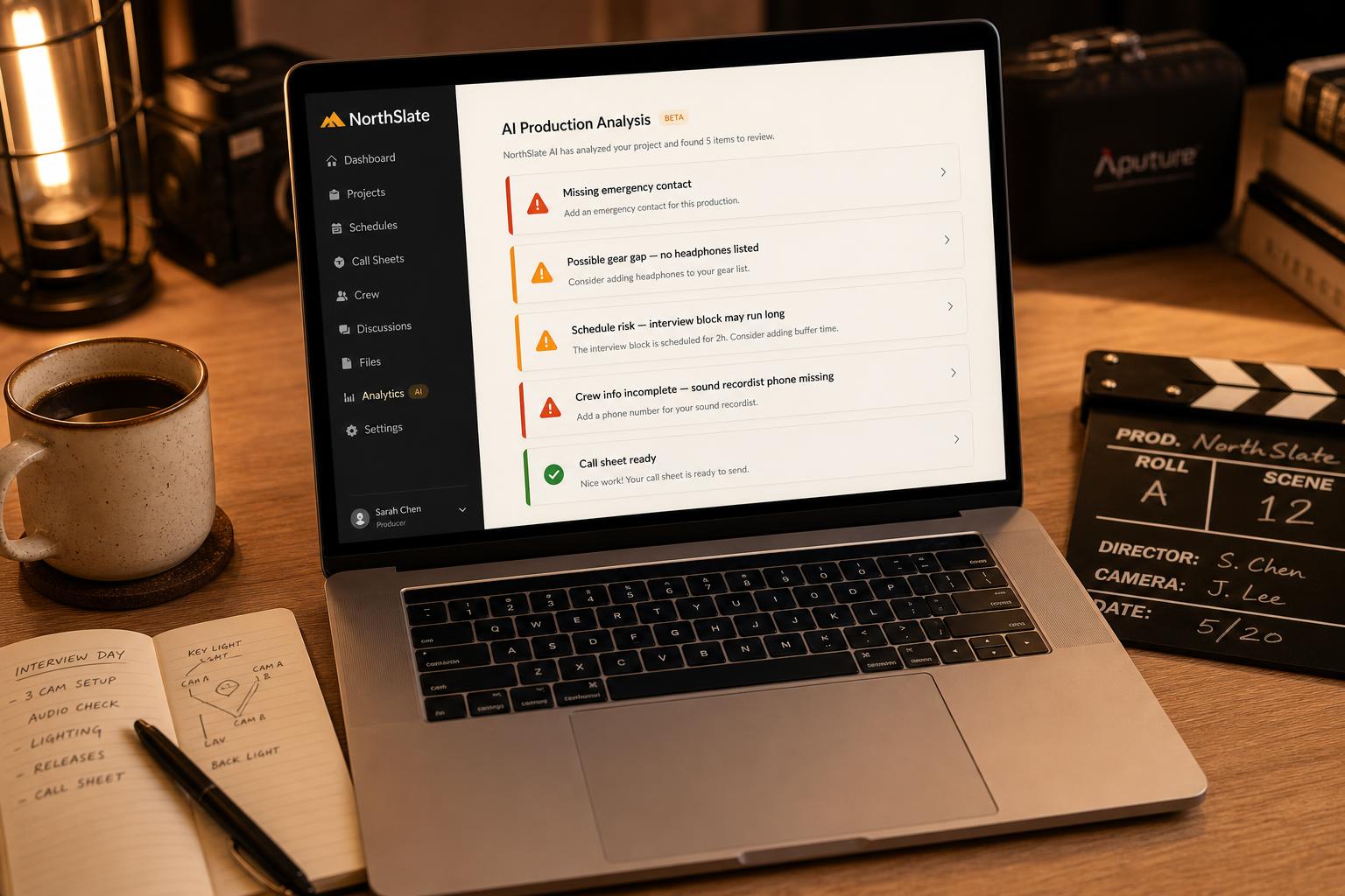 NorthSlate AI Production Analysis open on a laptop at a production desk with a clapperboard and notebook.